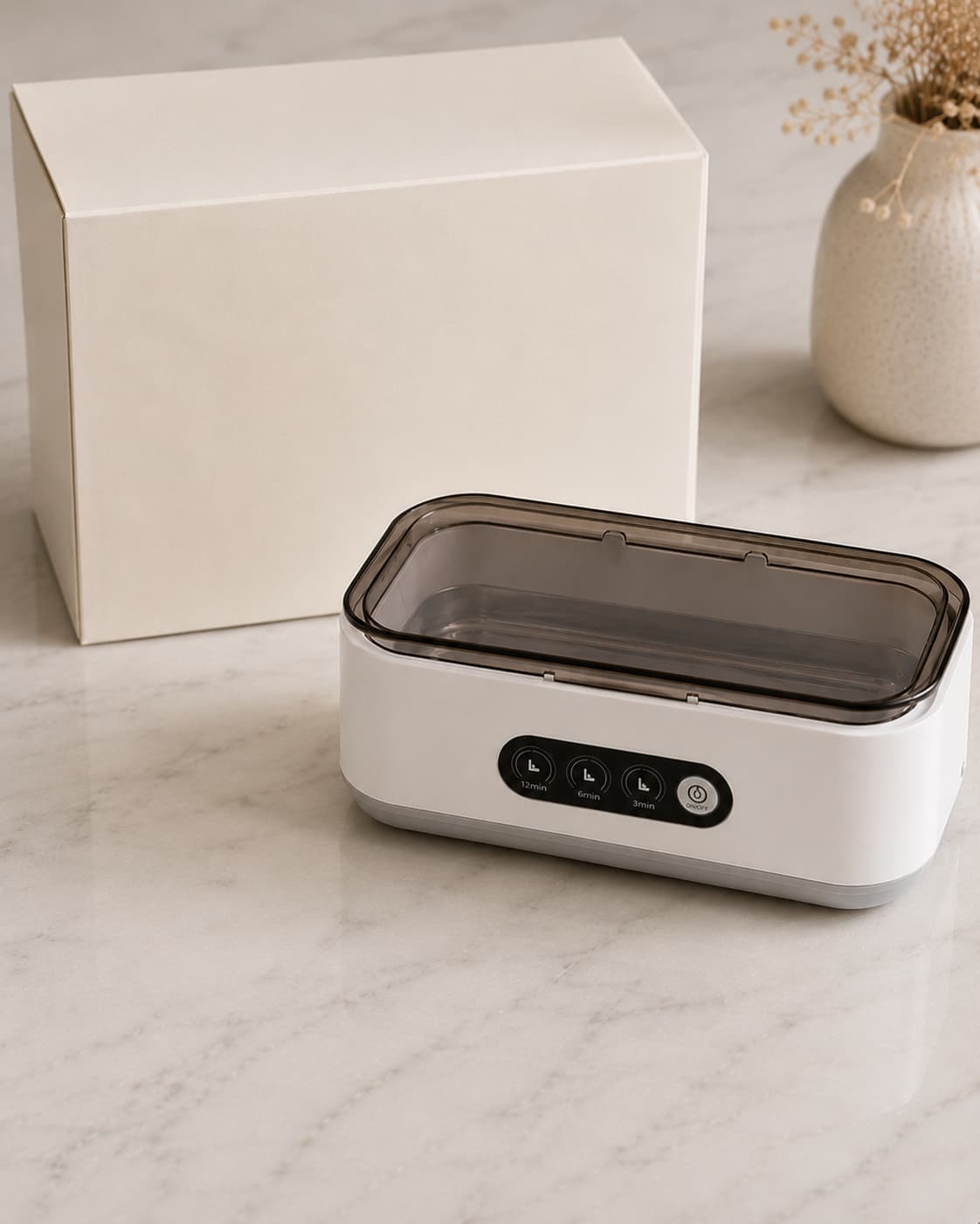 Aurelle Sparkle Bath jewelry cleaner next to its retail gift box on a marble countertop