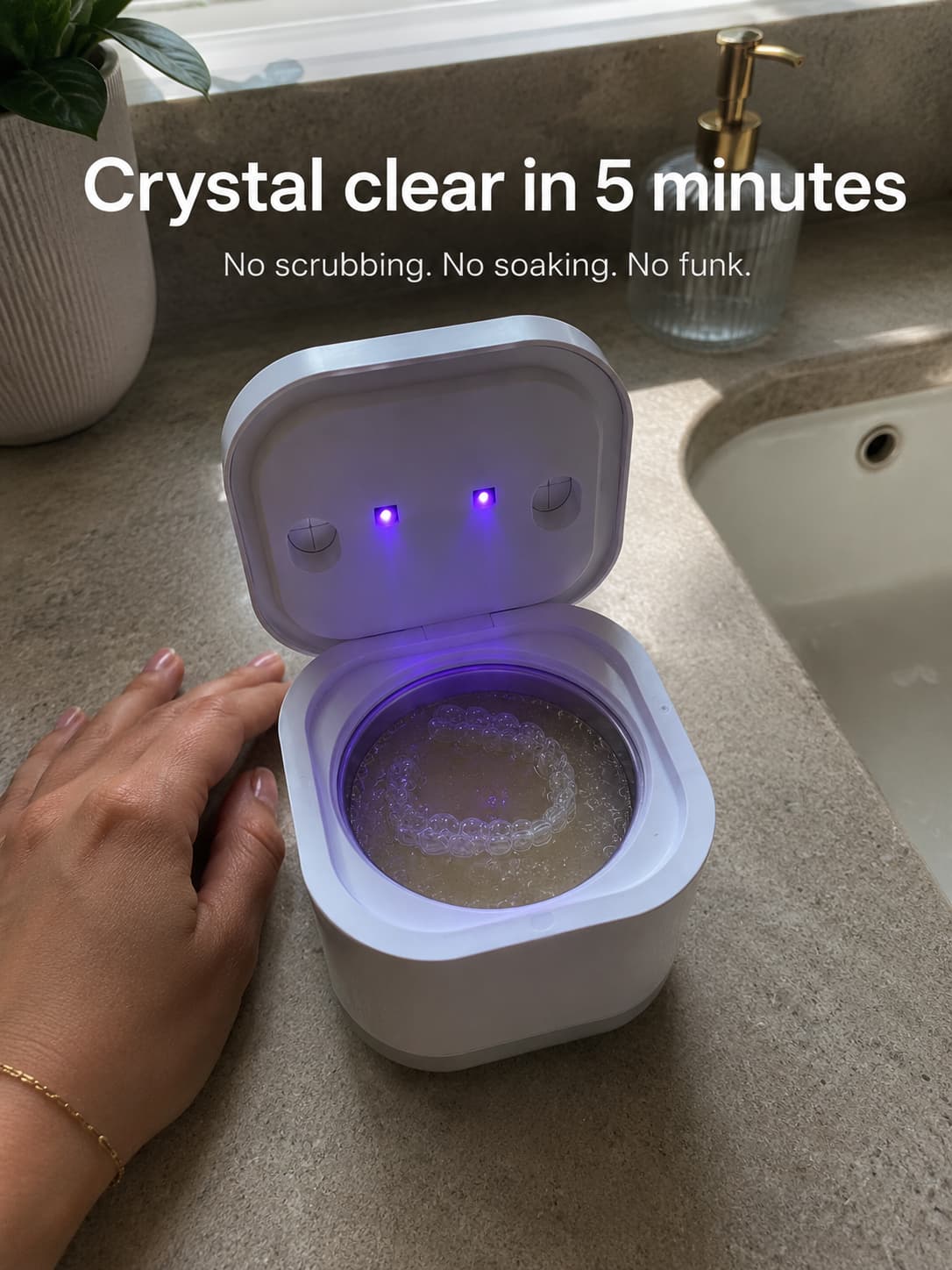 Aurelle ultrasonic cleaner with the lid open showing the cleaning basket